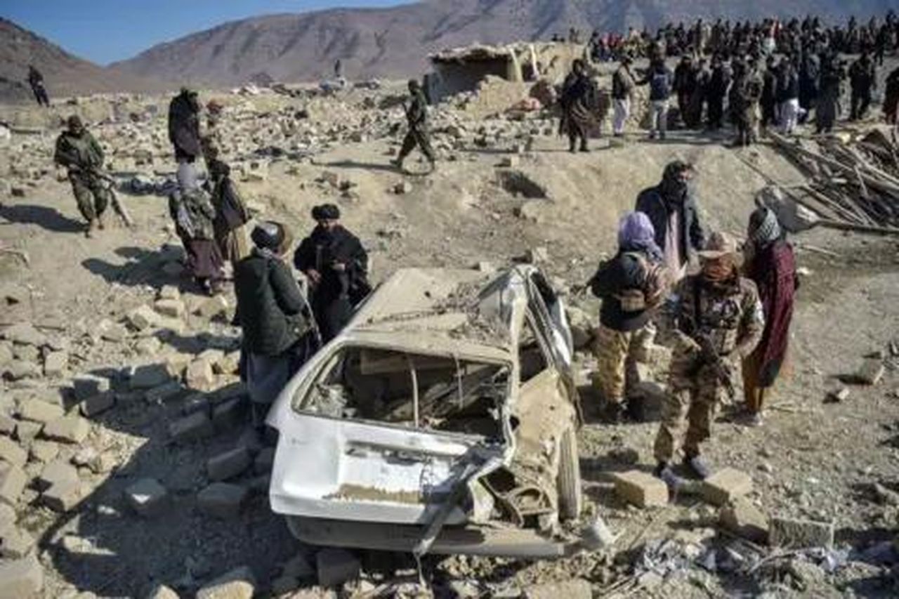 source:BBC World News - Le reazioni internazionali - Il personale di sicurezza talebano ispeziona un'auto danneggiata dopo attacchi aerei in Afghanistan.